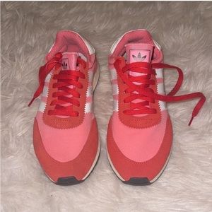 - Pink and red adidas sneakers